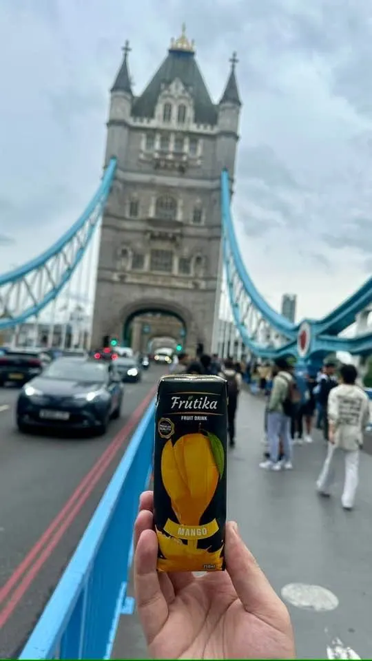 A Frutika Mango carton held up on Tower Bridge, London